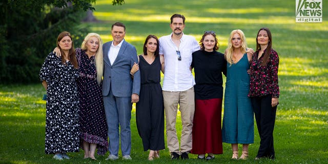 Murdered Crypto doctor's family of eight people stand together