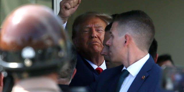 Former U.S. President Donald Trump waves as he makes a visit to the Cuban restaurant Versailles