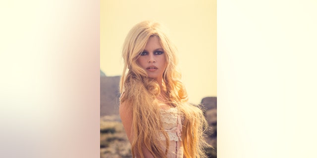 Brigitte Bardot wearing an ivory lace dress