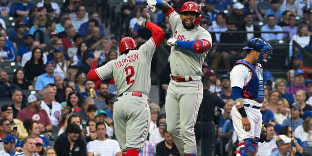 Edmundo Sosa and Josh Harrison celebrate