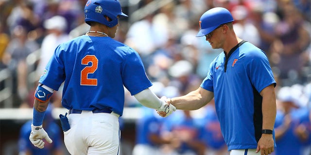 Ty Evans celebrates with third base coach