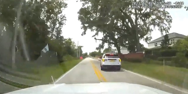 city cop pulled over, car shown via dash cam still