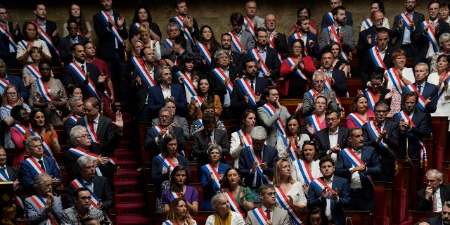 Lawmakers in France's National Assembly pay tribute to knife attack victims