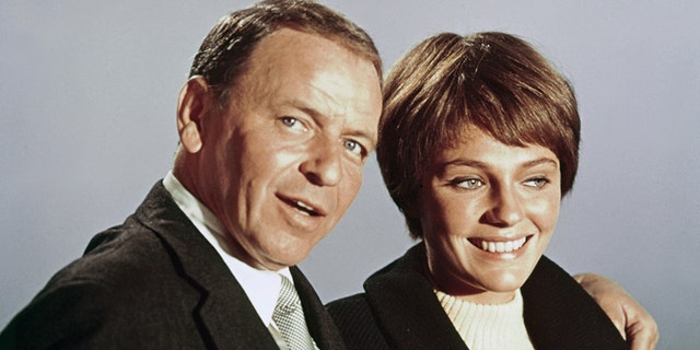 Frank Sinatra and Jacqueline Bisset pose for a photo