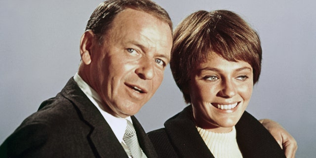 Frank Sinatra and Jacqueline Bisset pose for a photo