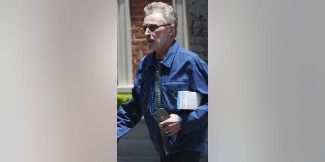 Frankie Valli walks outside wearing his new wedding ring