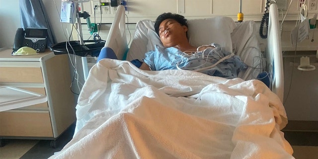 Gelvy Ortiz lays in a Santa Monica hospital bed with one leg missing