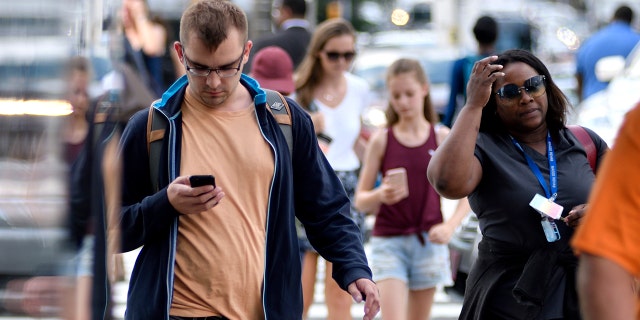 People walking with cell phones