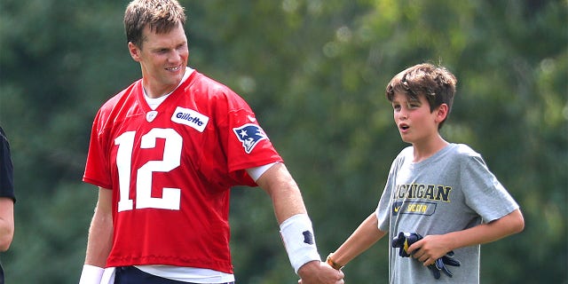 Tom Brady leaves the field with his son, Jack