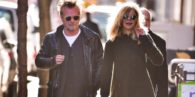 John Mellencamp and Meg Ryan hold hands wearing sunglasses while in New York City in 2018