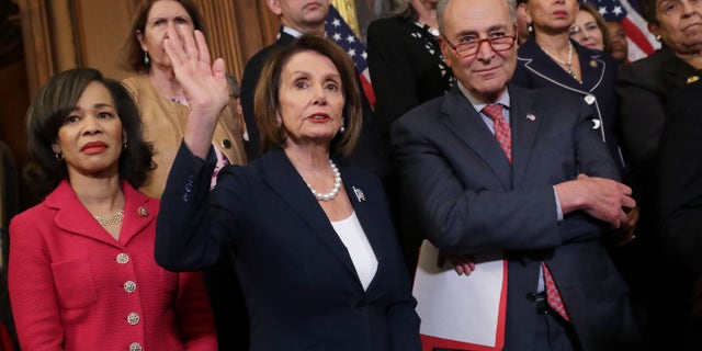 (L-R) Rep. Lisa Blunt Rochester, D-Del., Rep. Nancy Pelosi, D-Calif., Sen. Chuck Schumer, D-N.Y., and other congressional Democrats hold a rally and news conference ahead of a House vote on health care and prescription drug legislation in the Rayburn Room at the U.S. Capitol on May 15, 2019 in Washington, D.C.