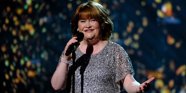 Susan Boyle in a sparkly short-sleeve dress sings on stage during "America's Got Talent"