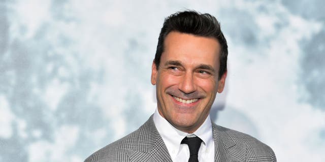 jon hamm smiling and looking off to the side