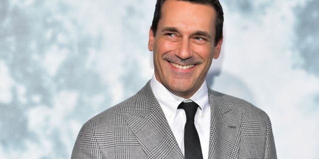 Jon Hamm smiles at a movie premiere