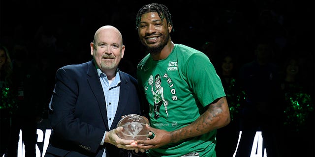 Marcus Smart receives the NBA Defensive Player of the Year Award