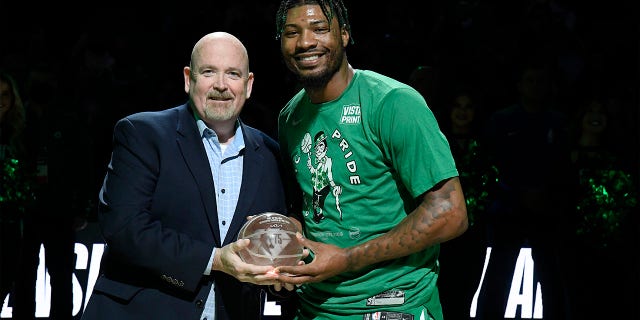 Marcus Smart receives the NBA Defensive Player of the Year Award