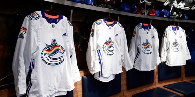 Vancouver Canucks Pride Night jerseys hang in the locker room