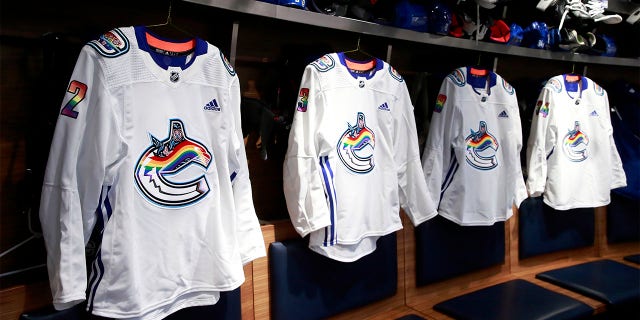 Vancouver Canucks Pride Night jerseys hang in the locker room