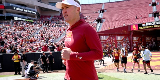 Lincoln Riley runs onto the field for USC's Spring Game