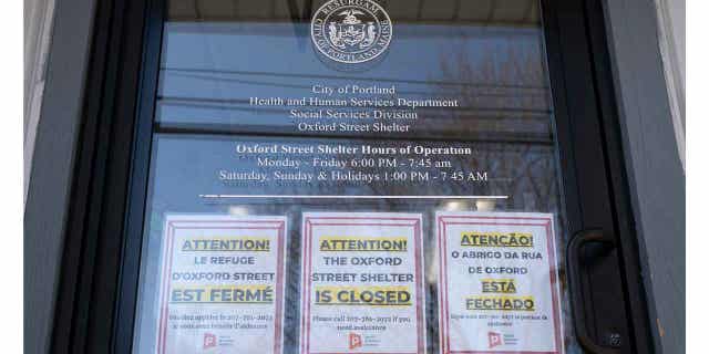 Signs on door of former homeless shelter