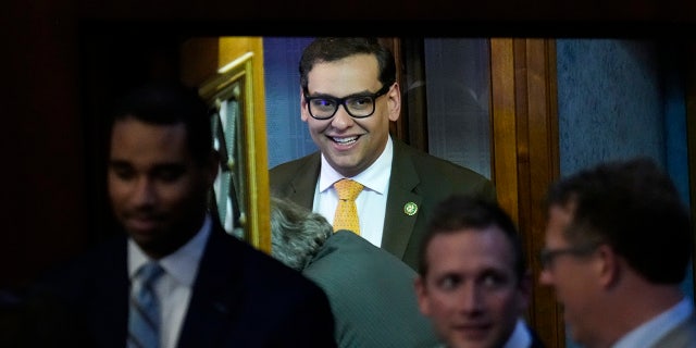 George Santos walks on the house floor
