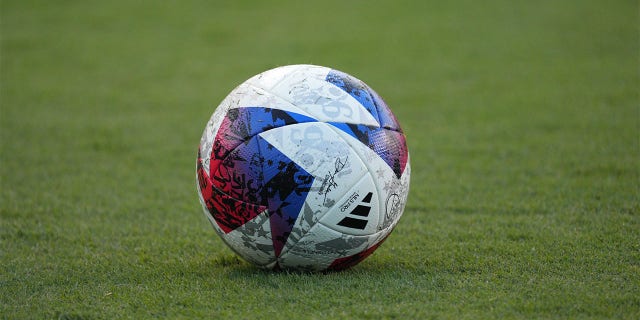 A soccer ball sits on the turf