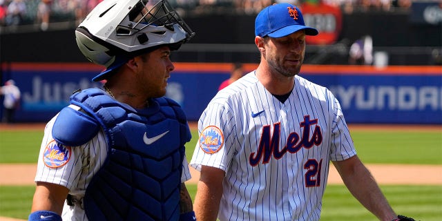 New York Mets' Francisco Alvarez and Max Scherzer walk off the field