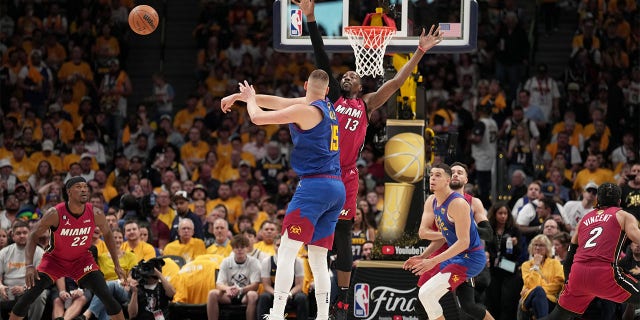 Nikola Jokic passes against the Miami Heat