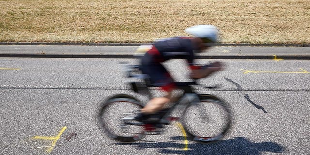 An athlete passes by the accident site.