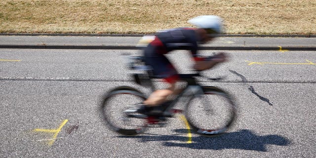 An athlete passes by the accident site.