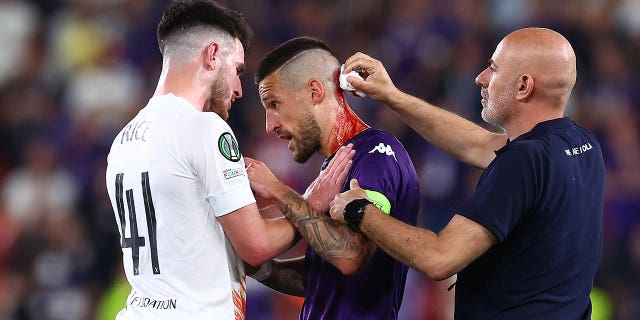 Cristiano Biraghi gets checked for a head wound