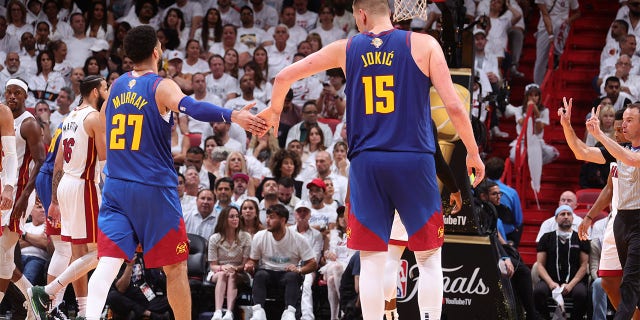 Jamal Murray high-fives Nikola Jokic