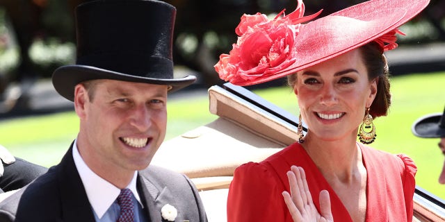 A photo of Prince William and Kate Middleton riding in a carriage