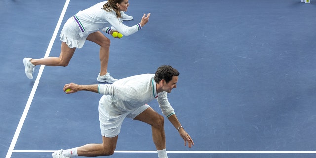 Kate Middleton and Roger Federer both make lunging motions as they toss tennis balls for Wimbledon