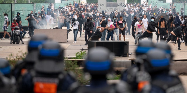 Protestors demonstrate in front of police