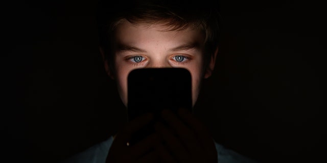 boy looking at mobile phone