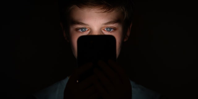 Boy looking at a phone