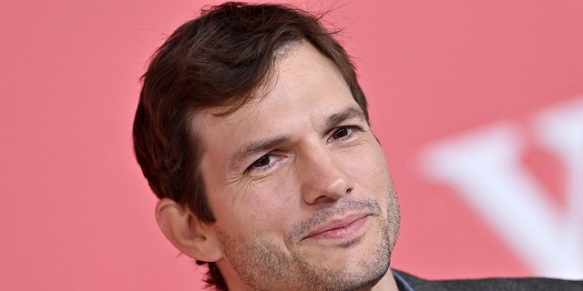 Ashton Kutcher soft smiles at the premiere of "Your Place Or Mine" in LA
