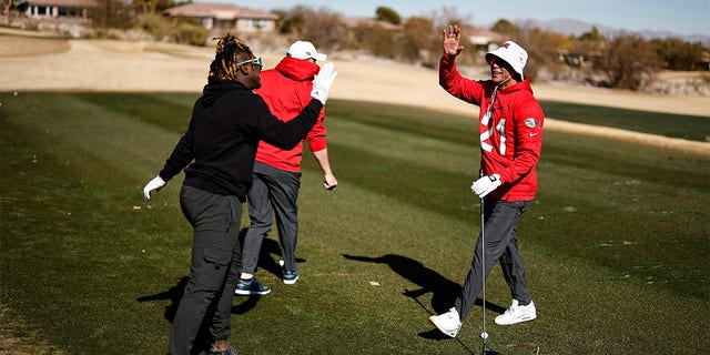 Jordan Poyer gives a high-five at a golf course