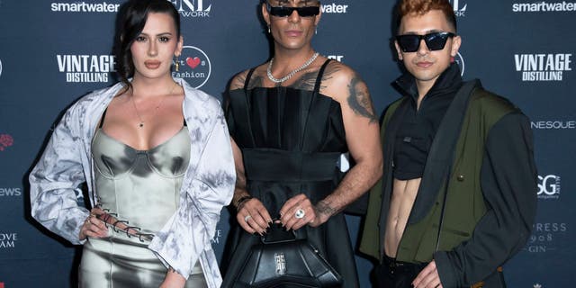 Rose Montoya, a transgender activist who is biologically male, stands next to two other transgender activists.
