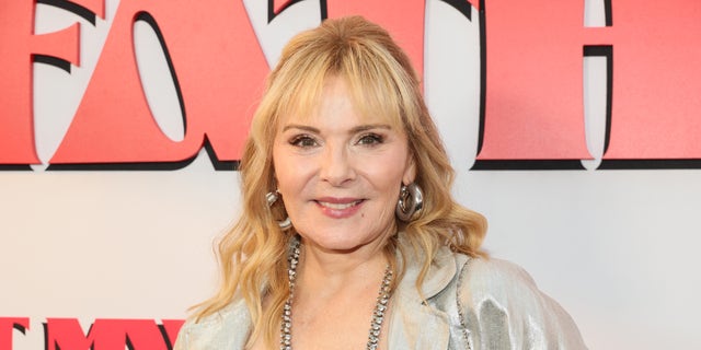 Close up of Kim Cattrall wearing silvery jacket on the red carpet