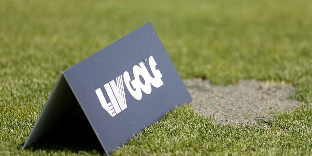 A LIV Golf sign on the practice range