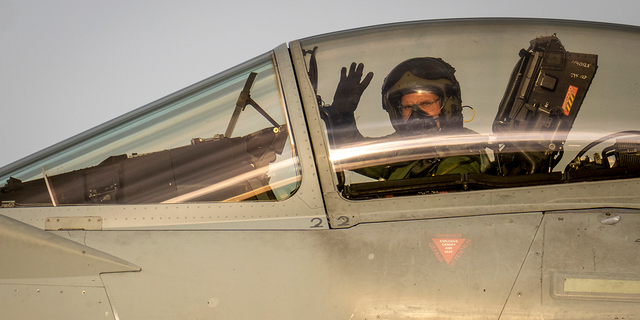 Airman waving in an aircraft