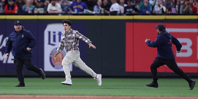 Fans running on a field at Seattle's T-Mobile Park