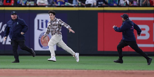 Fan runs on the field at Seattle's T-Mobile Park