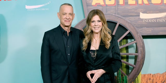 Tom Hanks in a black suit with Rita Wilson in a black pantsuit