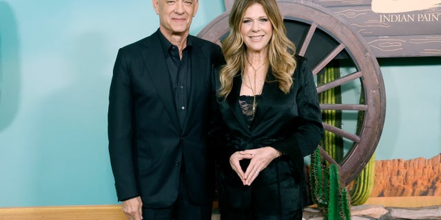 Tom Hanks in a black suit with Rita Wilson in a black pantsuit