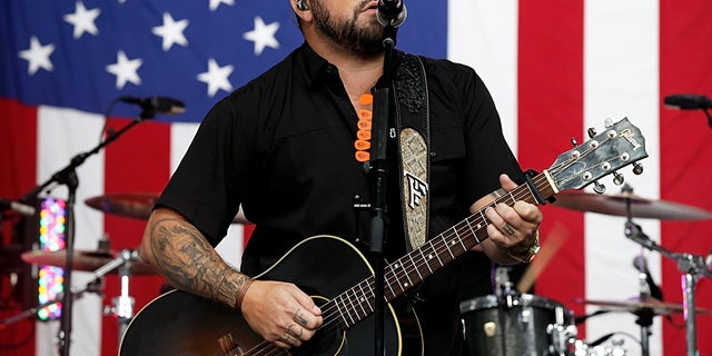 Tyler Farr playing guitar onstage