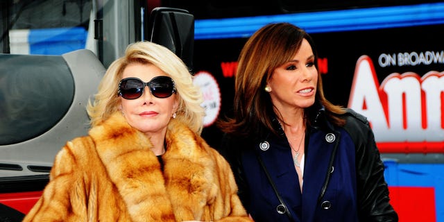 Joan Rivers in a fur coat and sunglasses with Melissa Rivers in a blue coat