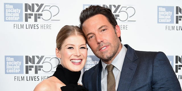 Rosamund Pike and Ben Affleck pose for a photo together.